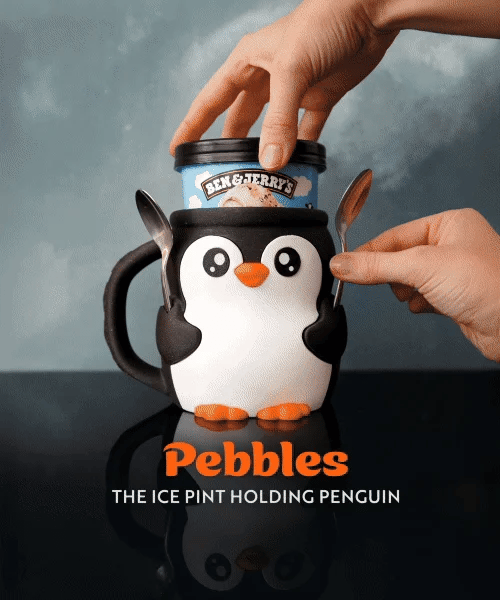 Penguin-shaped ice cream container with a hand holding a spoon, set against a dark background.